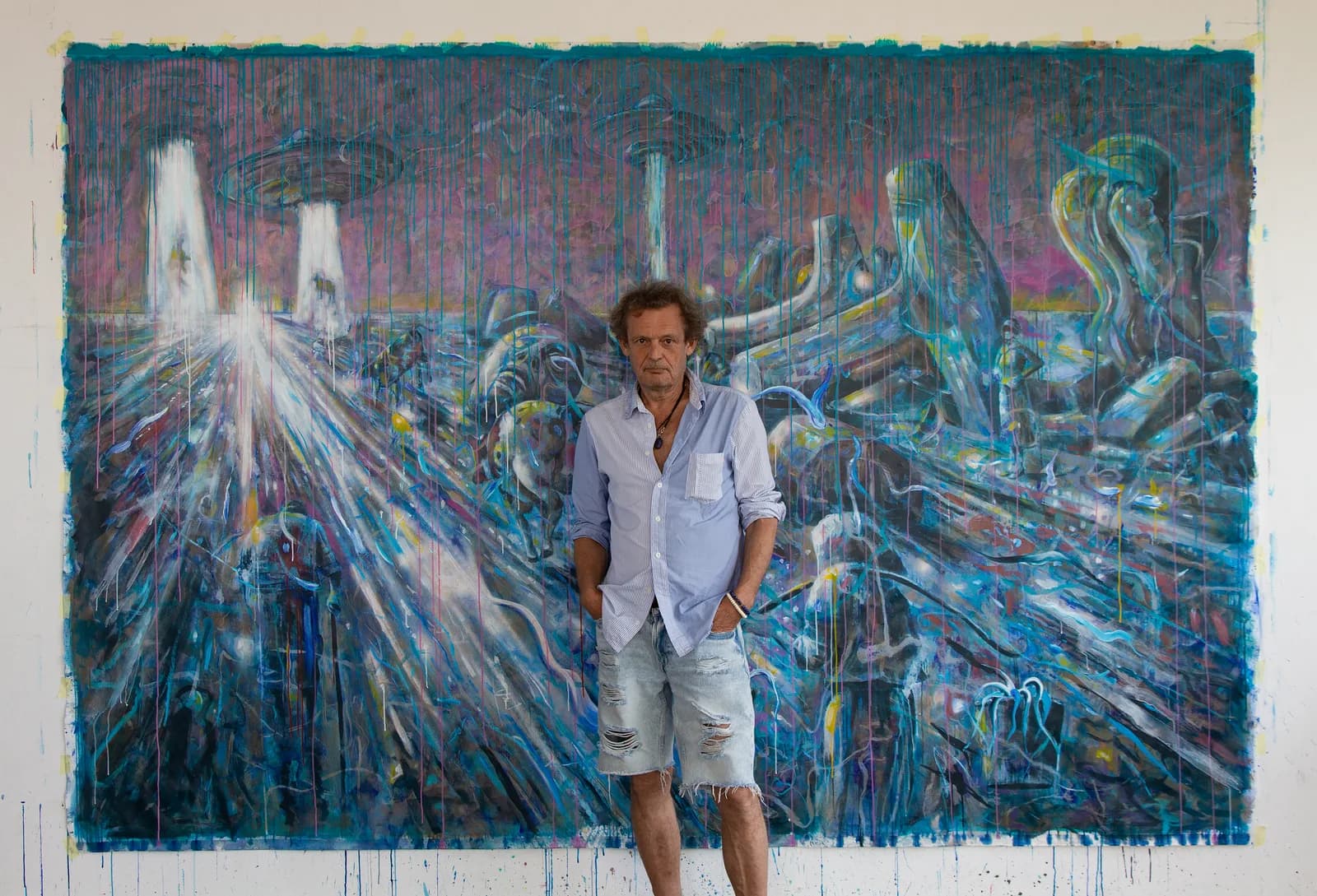 Don Schwab in his studio, in front of the painting Under New Management